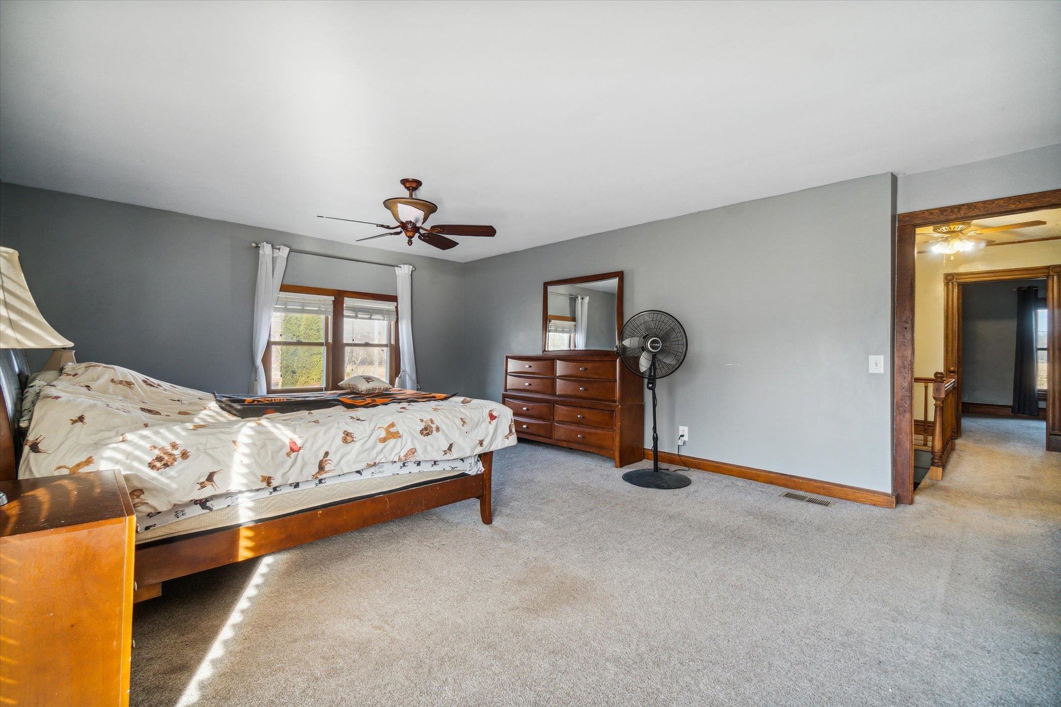14188 Beloit Road Caledonia, IL 61011 - Photo 29 of 42 a bedroom with bed and a chandelier