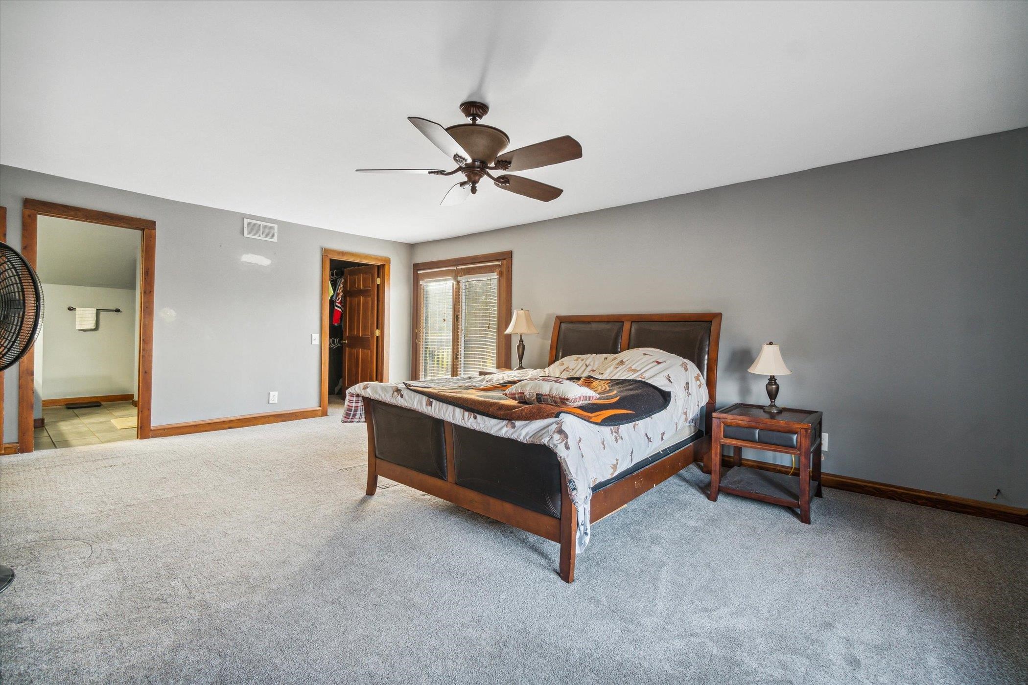 14188 Beloit Road Caledonia, IL 61011 - Photo 30 of 42 a bed room with a bed and a chandelier