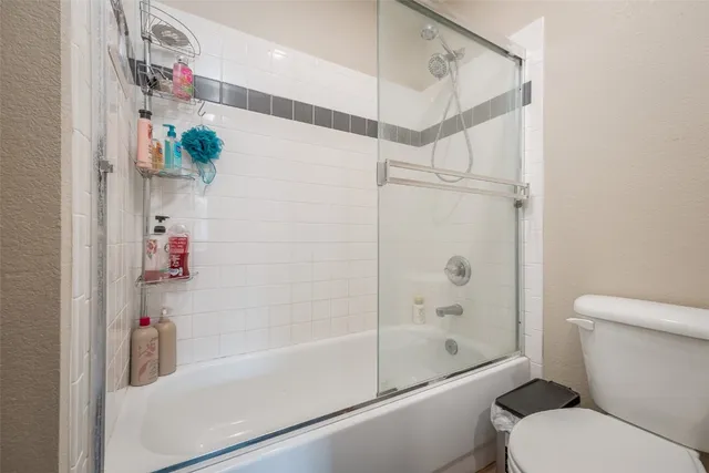 a bathroom with a shower and a toilet