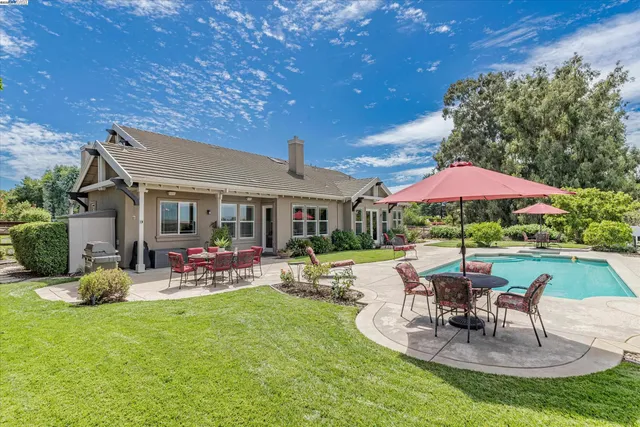 swimming pool view with a seating space
