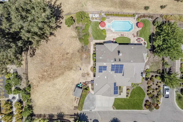 an aerial view of residential house with outdoor space and parking