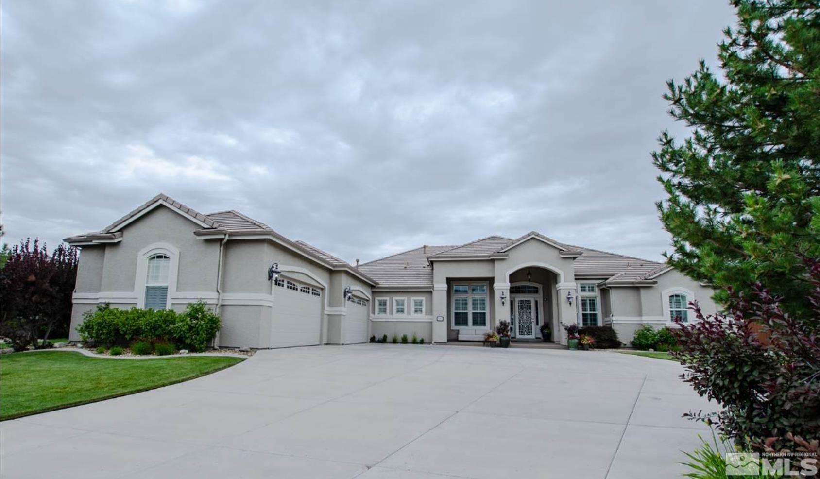 6982 Peacepipe Court Reno, NV 89511 - Photo 1 of 28 a front view of a house with yard and garage