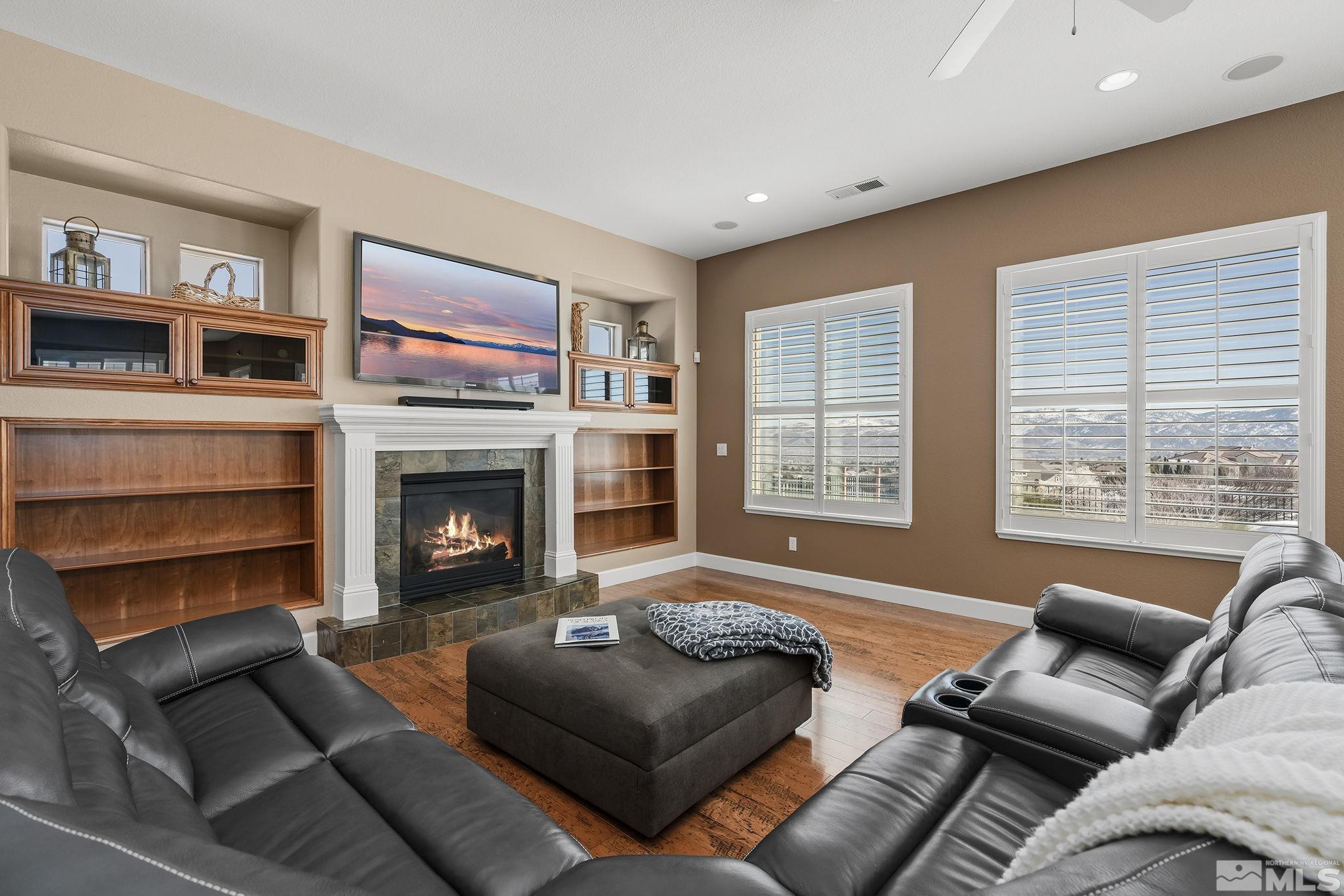 6982 Peacepipe Court Reno, NV 89511 - Photo 12 of 28 a living room with furniture window and a fireplace