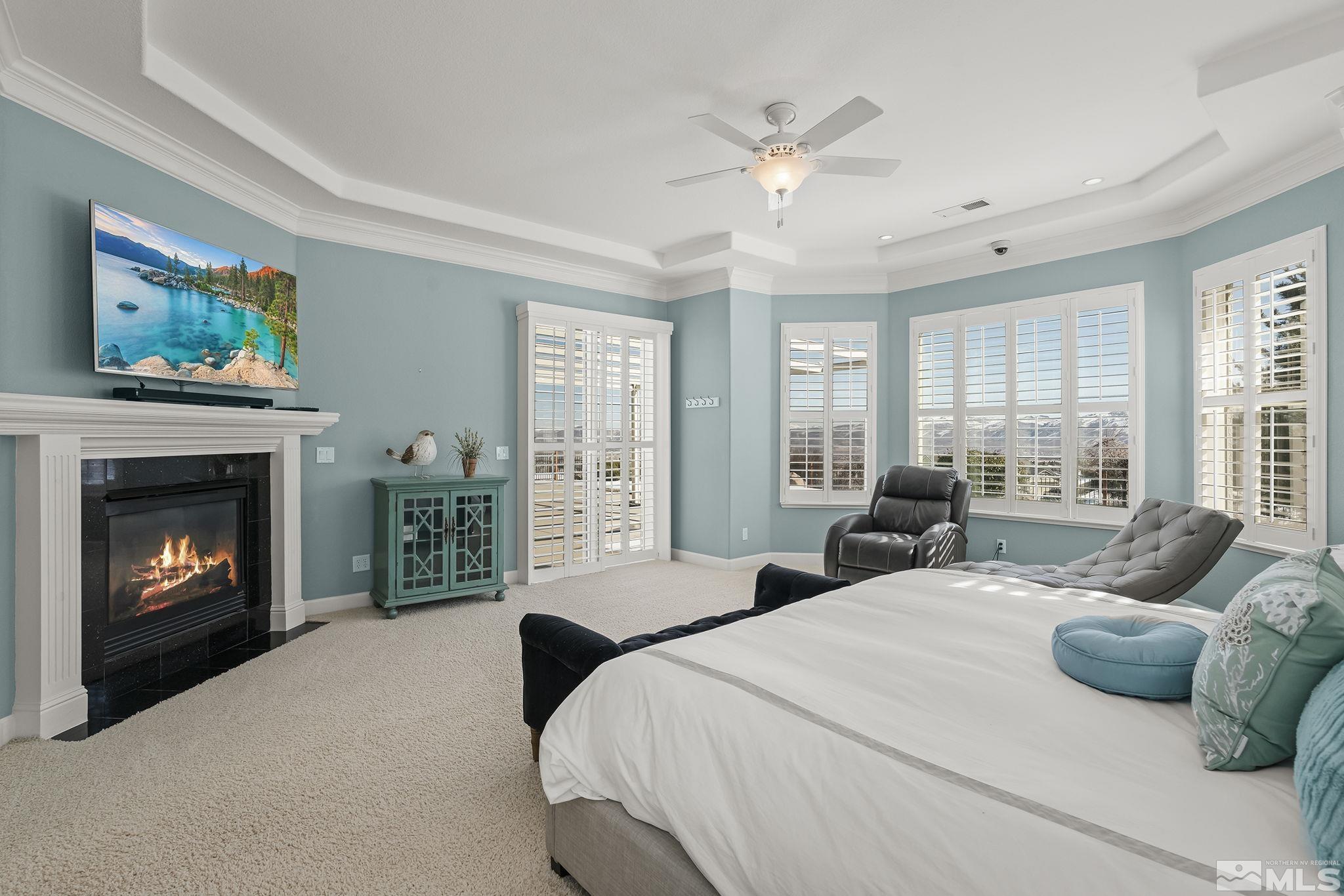 6982 Peacepipe Court Reno, NV 89511 - Photo 13 of 28 a bedroom with a bed and a fireplace