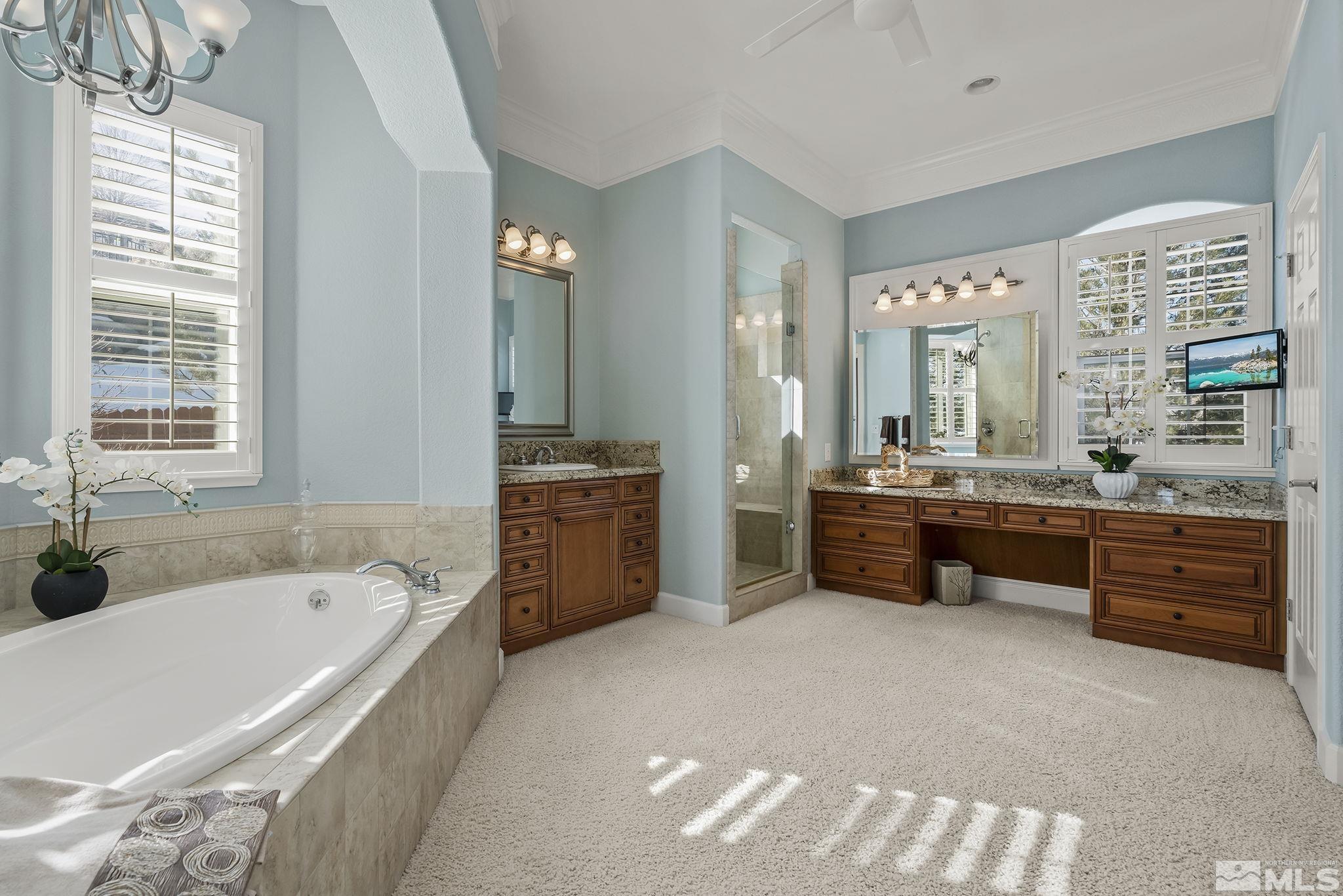 6982 Peacepipe Court Reno, NV 89511 - Photo 15 of 28 a bathroom with a tub sink and mirror