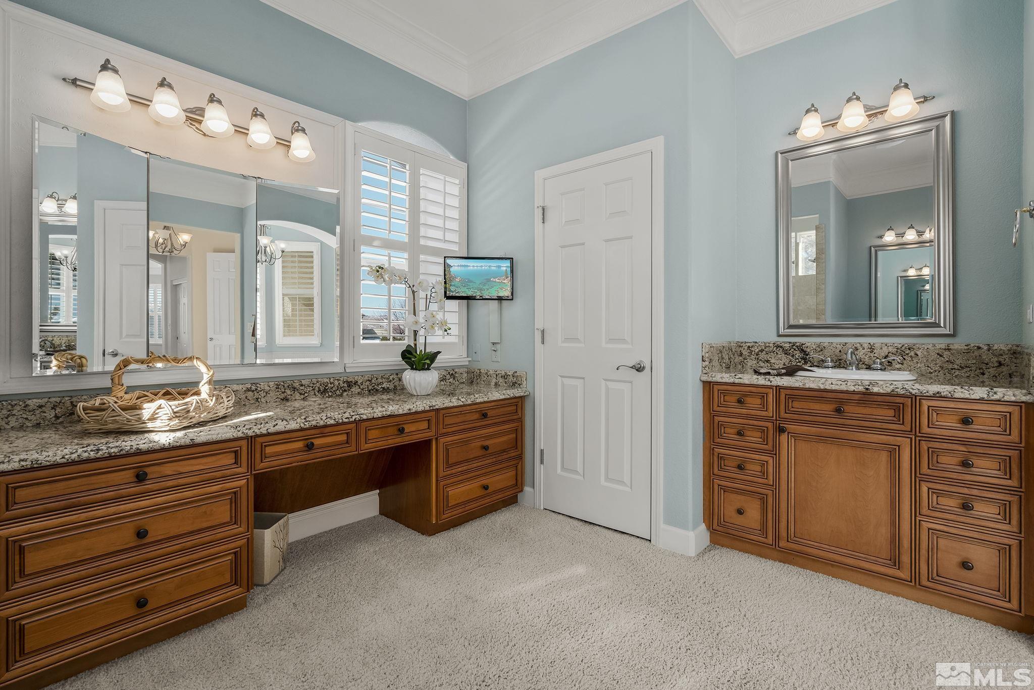 6982 Peacepipe Court Reno, NV 89511 - Photo 16 of 28 a bathroom with a granite countertop double vanity sink and a mirror