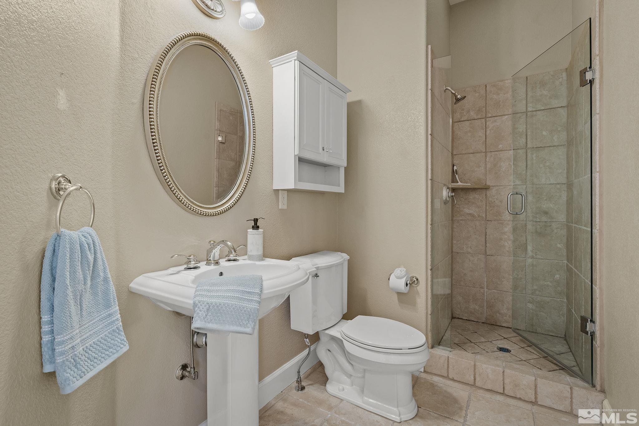6982 Peacepipe Court Reno, NV 89511 - Photo 20 of 28 a bathroom with a sink toilet and shower