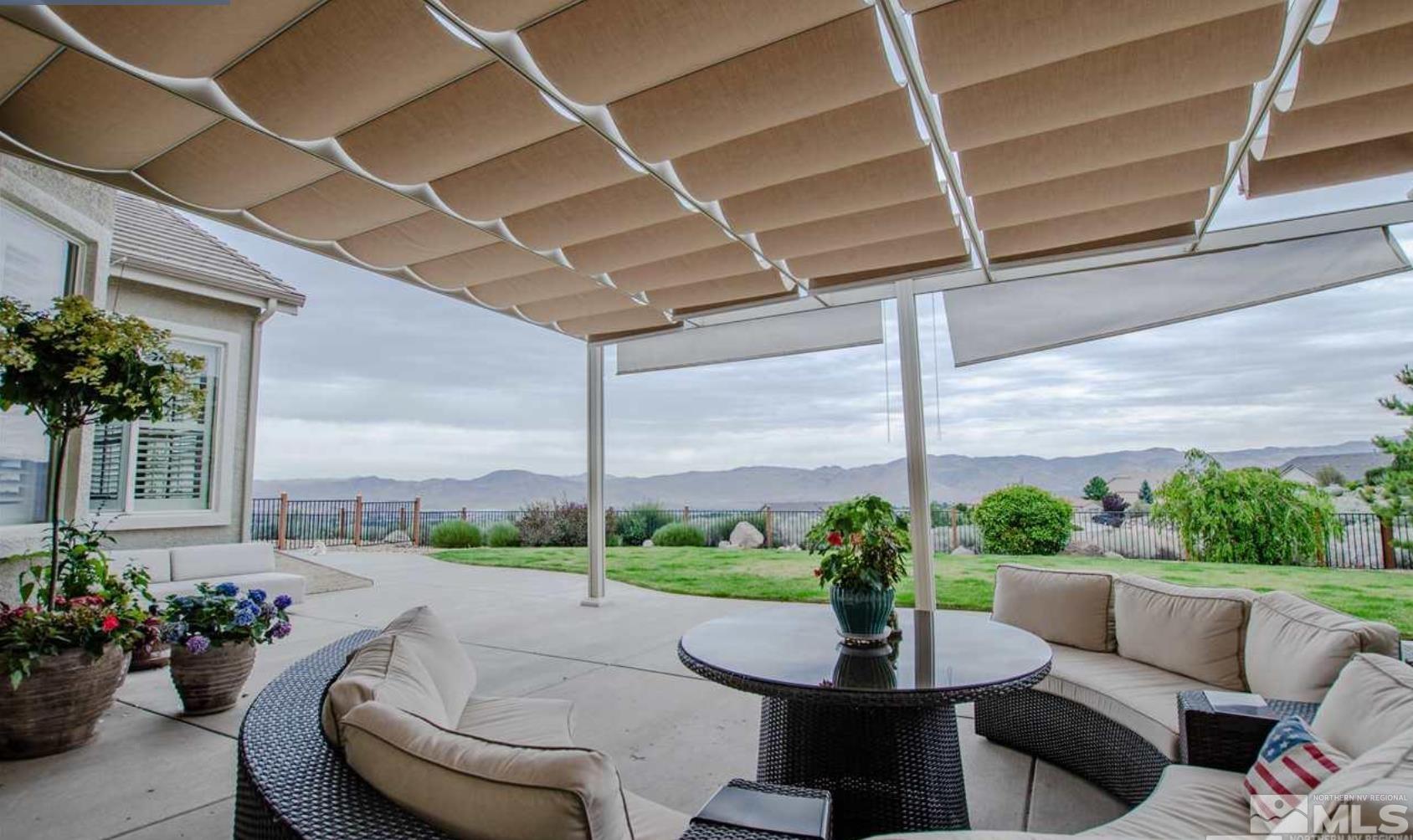 6982 Peacepipe Court Reno, NV 89511 - Photo 22 of 28 a living room with patio furniture and a potted plant