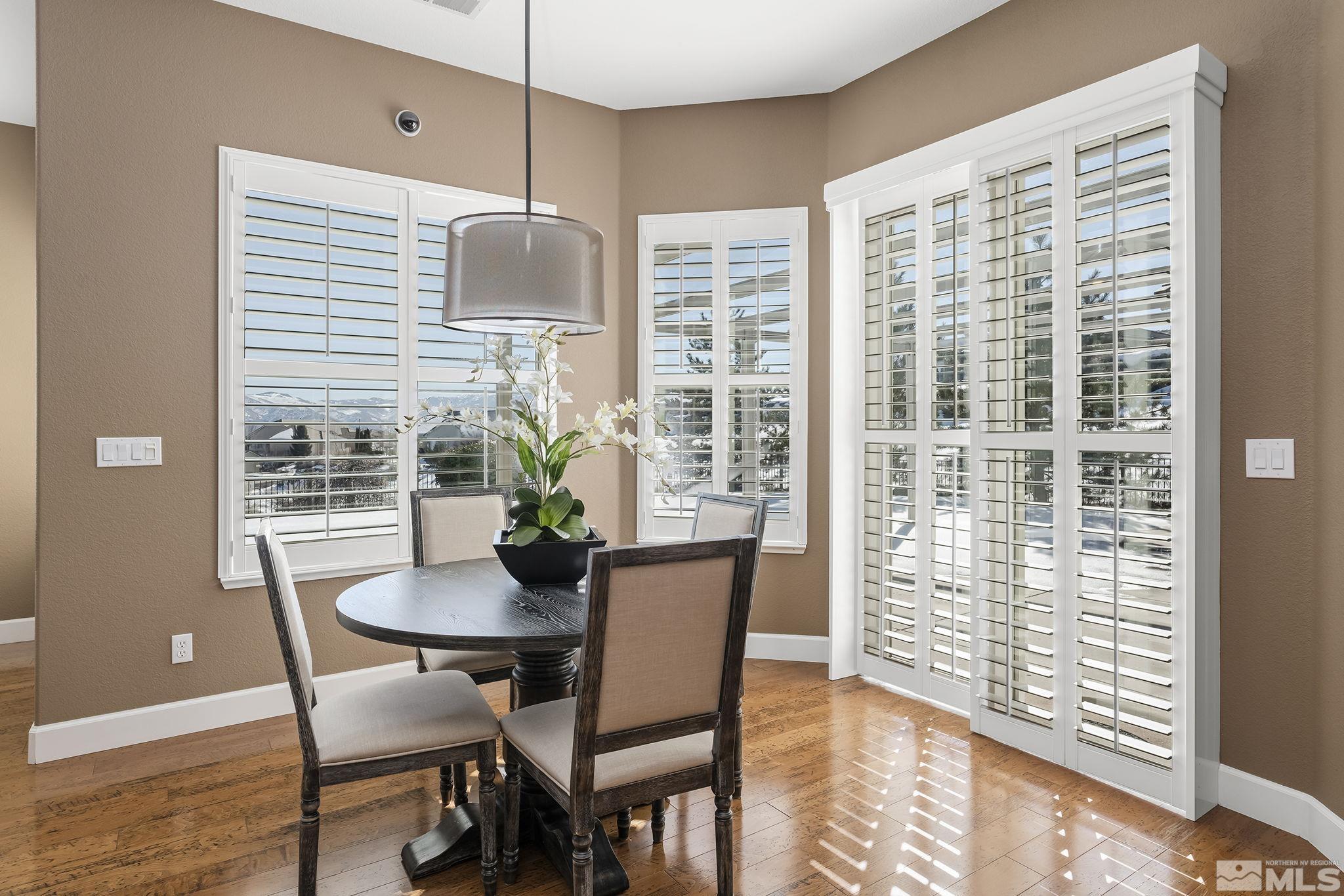 6982 Peacepipe Court Reno, NV 89511 - Photo 9 of 28 a dining room with furniture and wooden floor