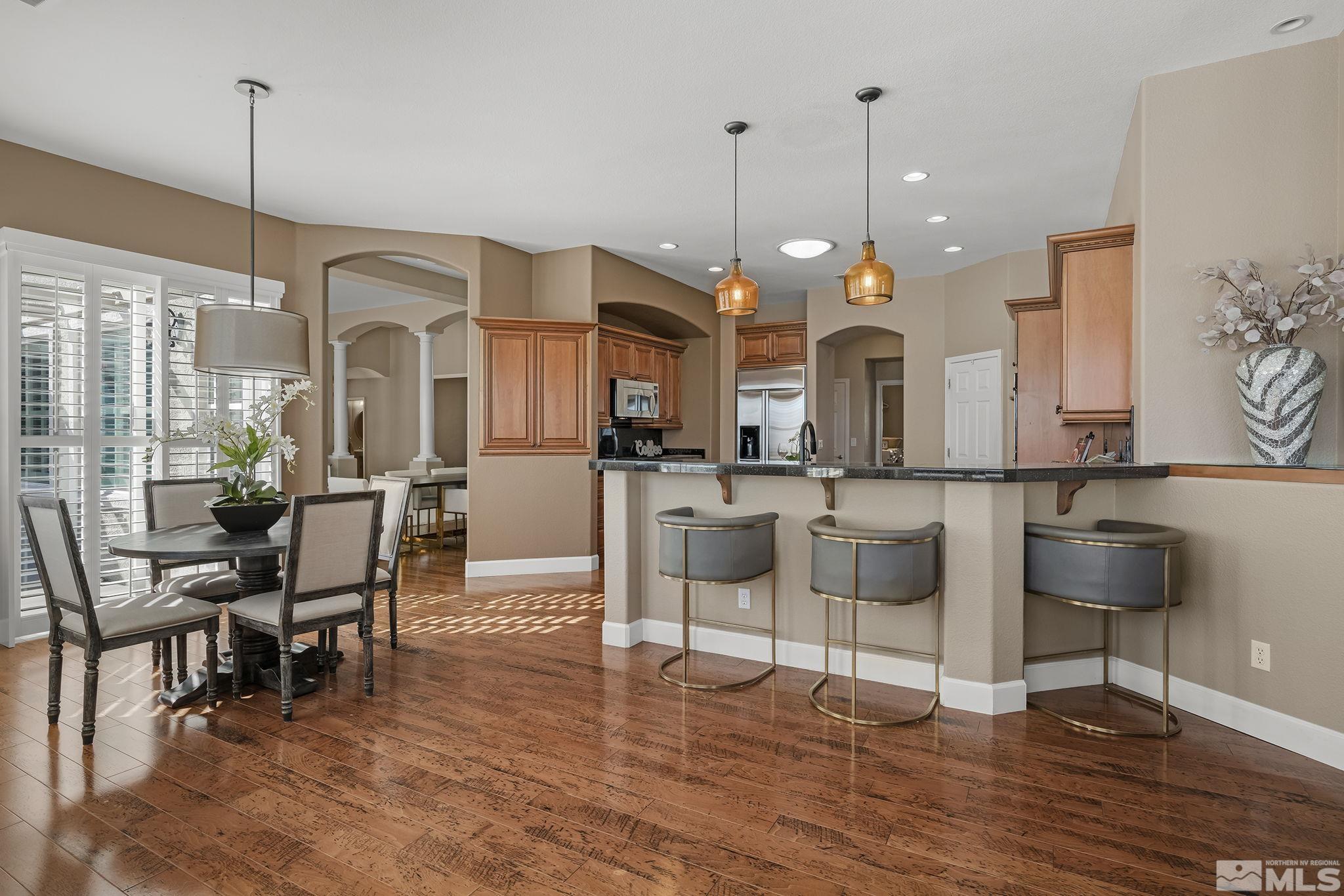 6982 Peacepipe Court Reno, NV 89511 - Photo 10 of 28 a large kitchen with a table and chairs