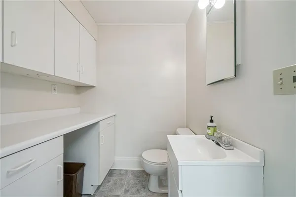 a bathroom with a sink a toilet and vanity