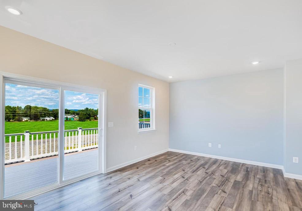 154 Cooperage Road Inwood, WV 25428 - Photo 3 of 19 an empty room with wooden floor and windows
