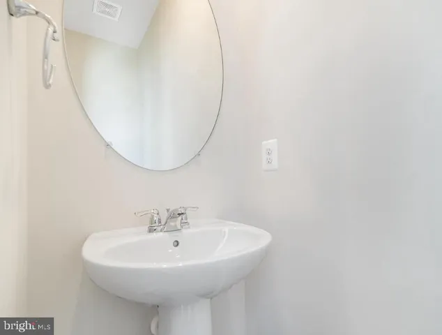 a white sink sitting next to a white bathroom