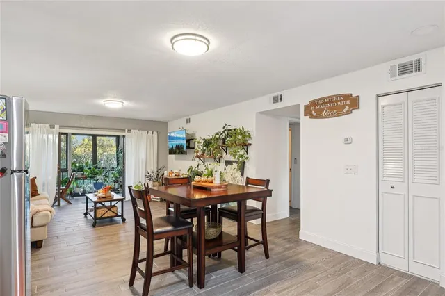 a dining room with furniture and wooden floor