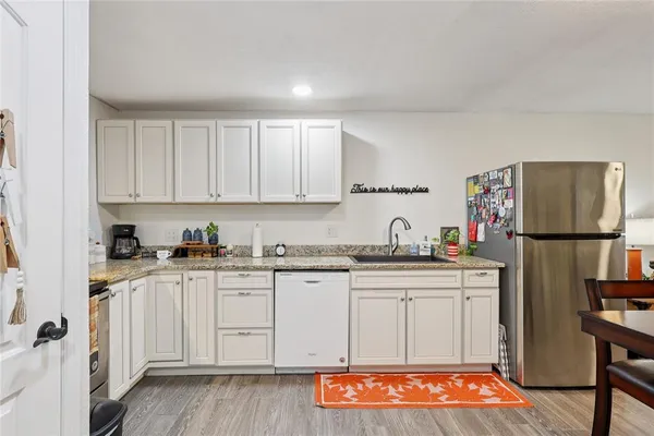 a kitchen with stainless steel appliances granite countertop a stove a sink and a refrigerator