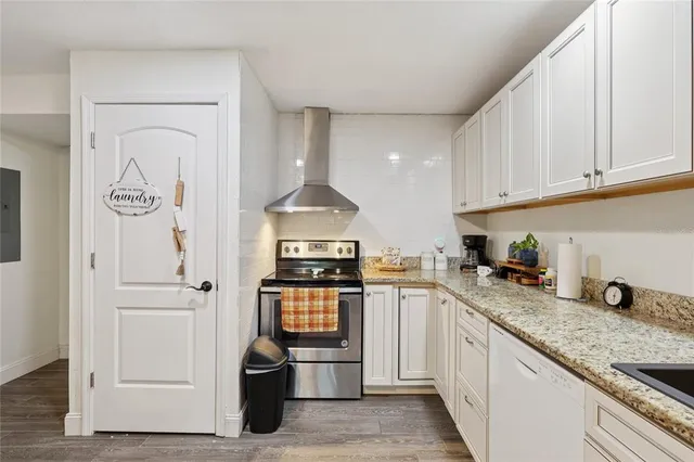 a kitchen with stainless steel appliances granite countertop a stove and a refrigerator