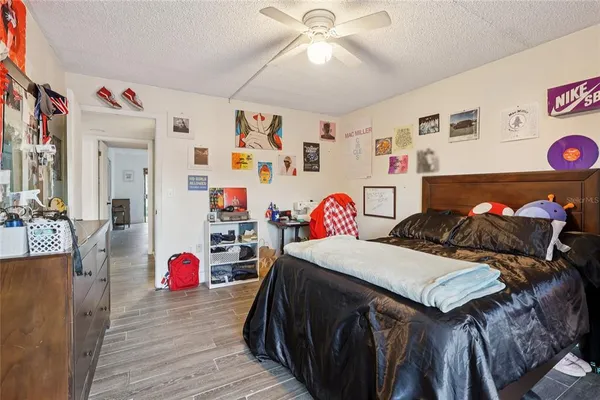 a living room with patio furniture and a potted plant