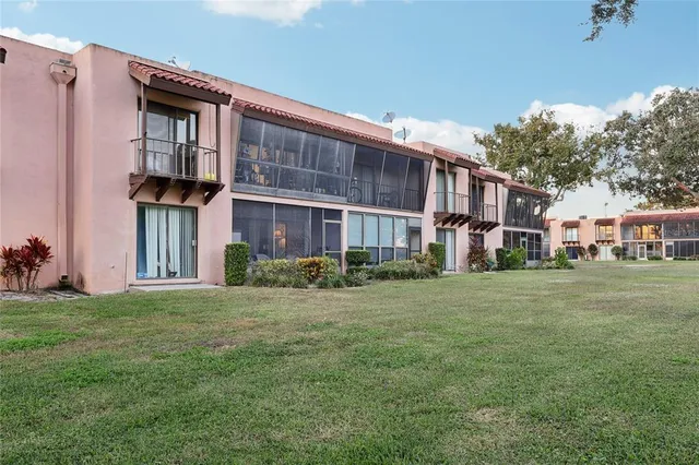 a front view of a building with a garden