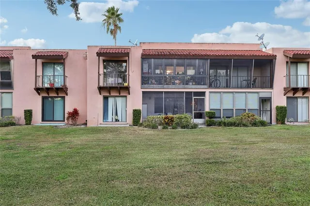 a view of a big room with a big yard and large trees