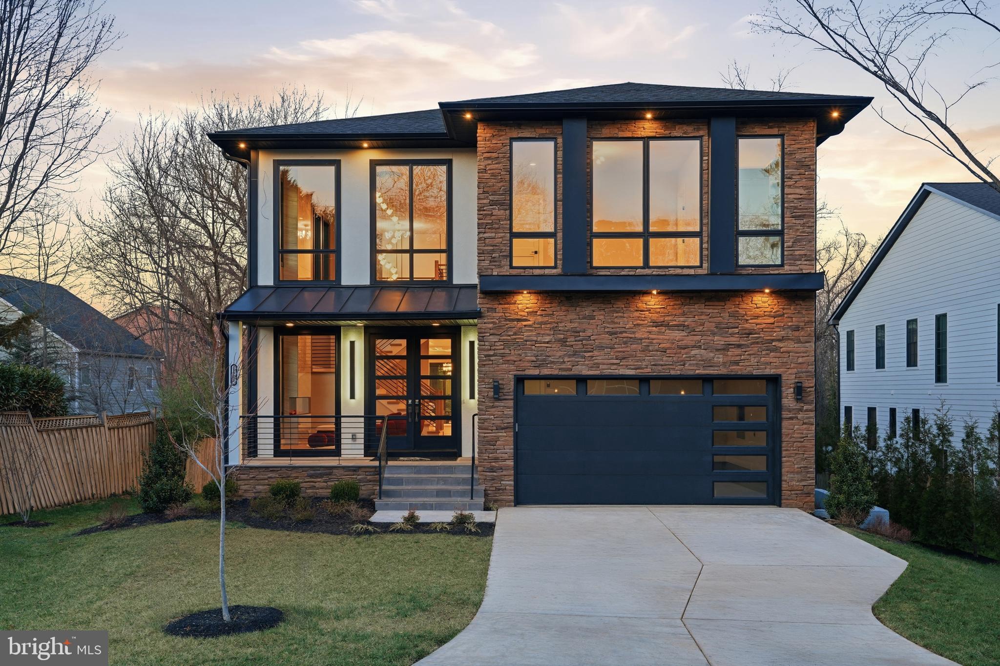 a front view of a house with a yard and outdoor seating