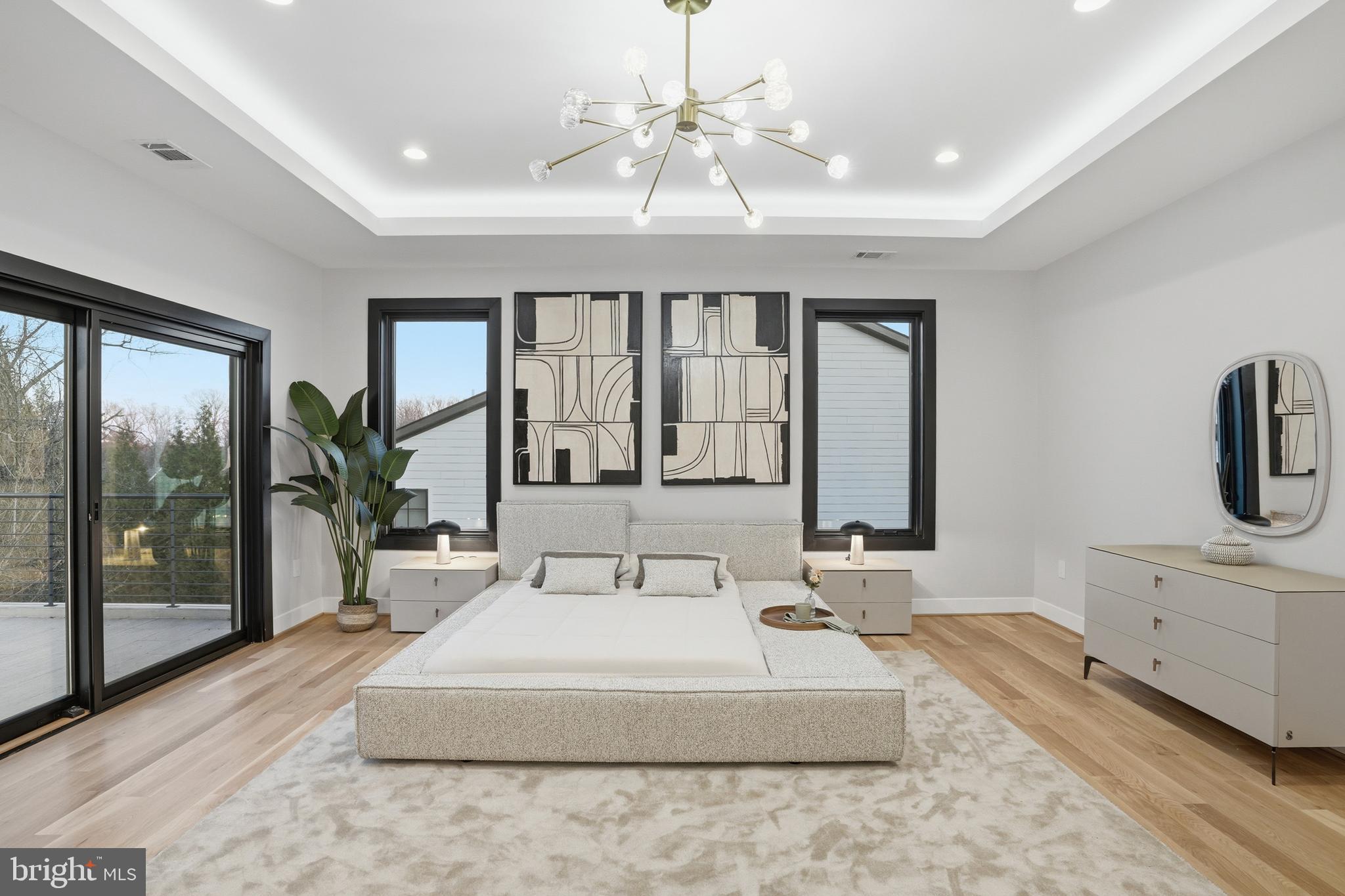 1805 Franklin Avenue McLean, VA 22101 - Photo 59 of 96 a spacious bedroom with a large bed and a chandelier fan