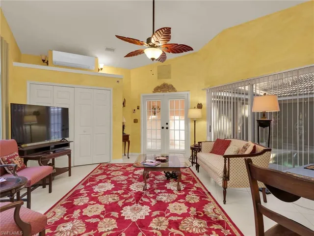 a bedroom with furniture and a flat screen tv