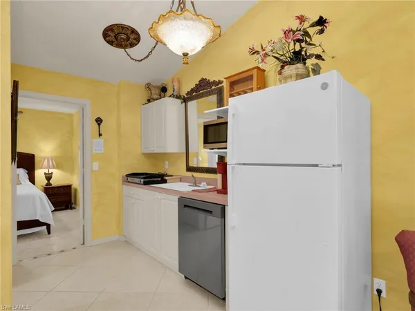 a kitchen with a refrigerator and a stove