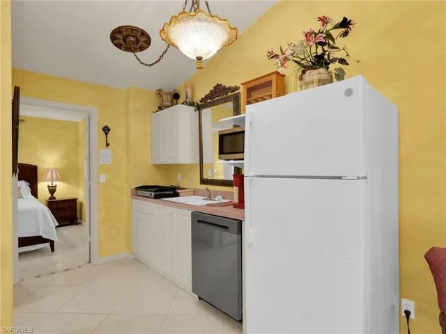 a kitchen with a refrigerator and a stove