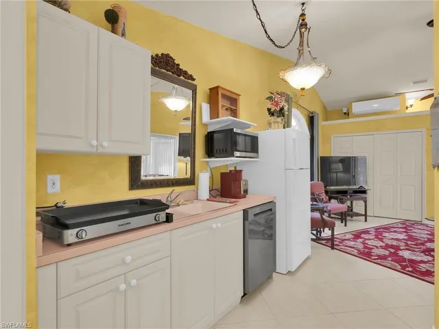 a kitchen that has a lot of cabinets in it