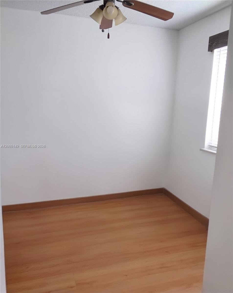 519 Talavera Road Weston, FL 33326 - Photo 16 of 19 wooden floor in an empty room