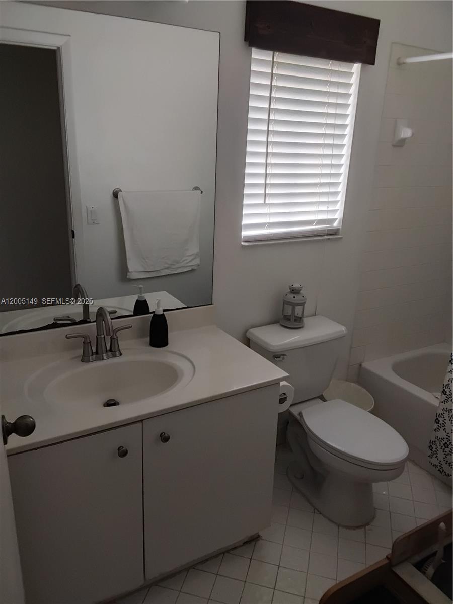 519 Talavera Road Weston, FL 33326 - Photo 18 of 19 a bathroom with a toilet sink and mirror