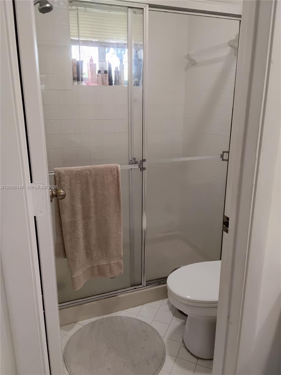 519 Talavera Road Weston, FL 33326 - Photo 19 of 19 a white toilet sitting next to a shower