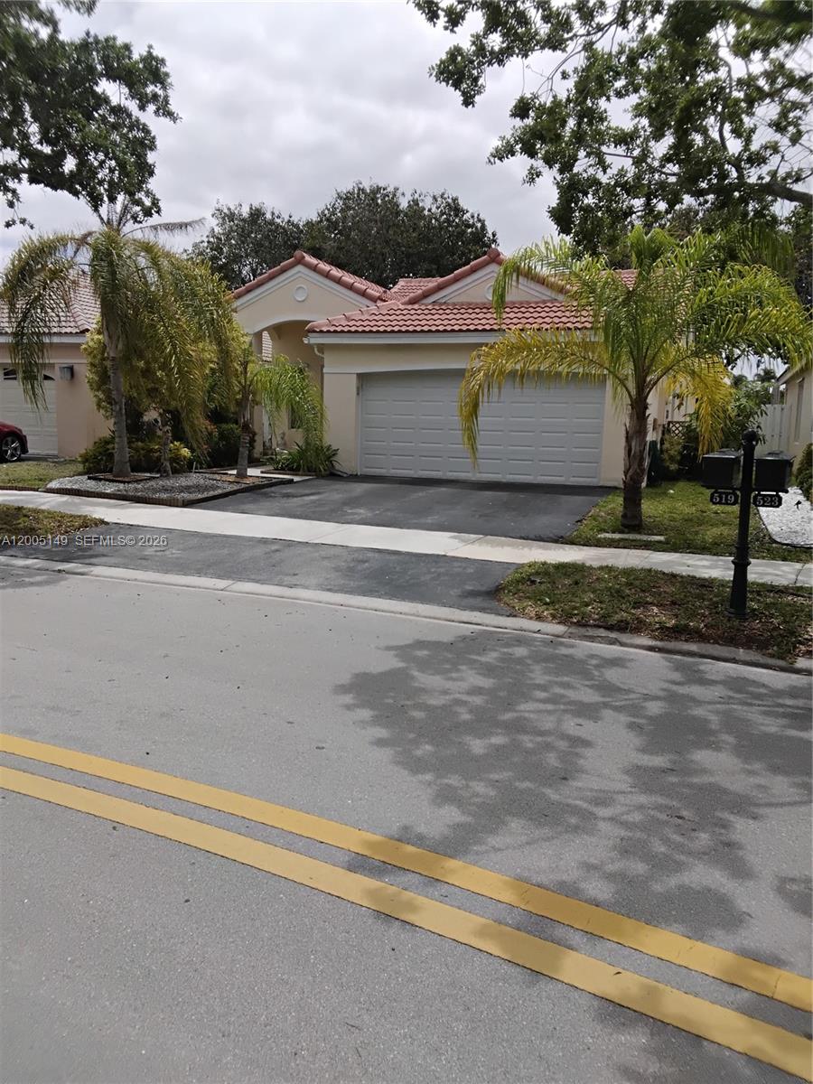 519 Talavera Road Weston, FL 33326 - Photo 2 of 19 a view of a house with a yard and large tree