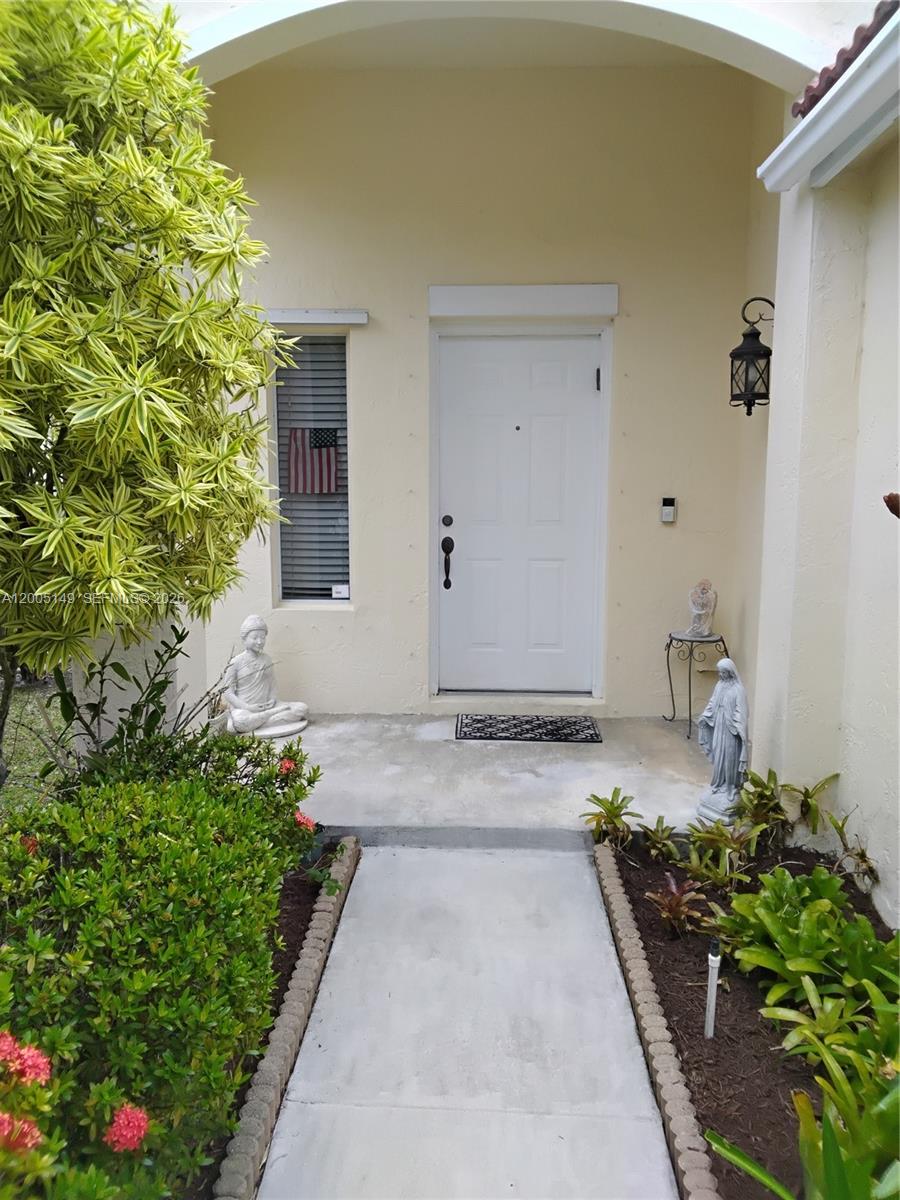 519 Talavera Road Weston, FL 33326 - Photo 3 of 19 a front view of a house with a yard