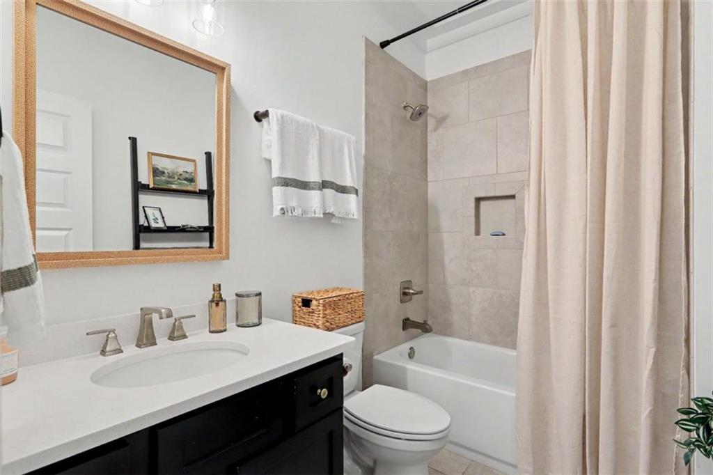 943 Clubside Drive Monroe, GA 30655 - Photo 38 of 93 a bathroom with a sink a toilet a mirror a vanity and shower