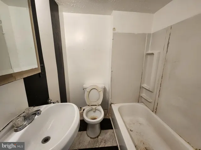 a kitchen with stainless steel appliances a refrigerator and a stove top oven