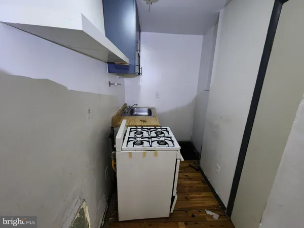 a kitchen with a refrigerator and a stove