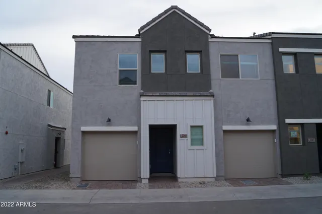 a front view of a house with garage