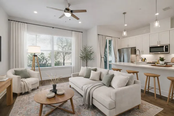 a living room with furniture and a large window