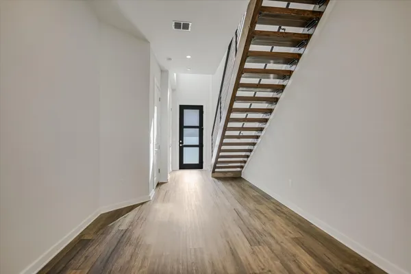 wooden floor in an empty room with stairs