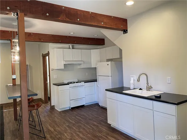 a kitchen with a sink cabinets and stainless steel appliances