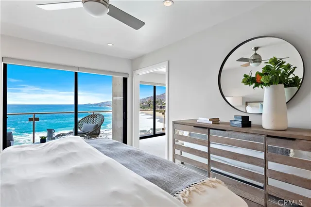 a bedroom with a bed a mirror on desk and a mirror