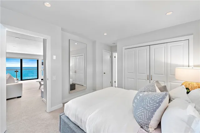 a bedroom with a large bed and a walk in closet