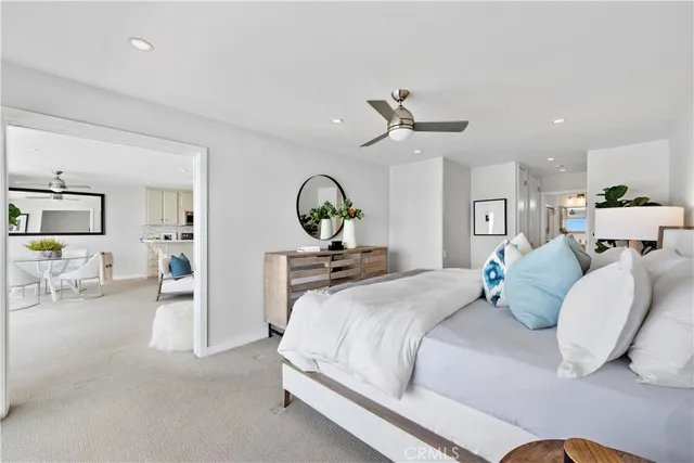 a bedroom with a bed and ceiling fan