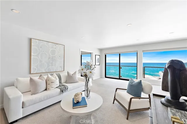 a living room with furniture and floor to ceiling window