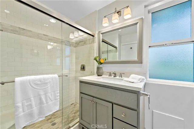 a bathroom with a double vanity sink mirror and