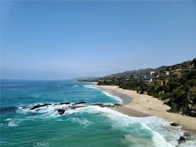 a view of a dining room with furniture a chandelier and wooden floor