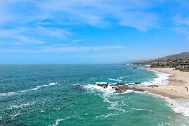 front view of a house with a yard and potted plants