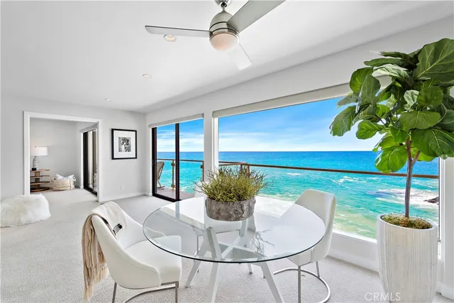 a dining room with furniture and a potted plant