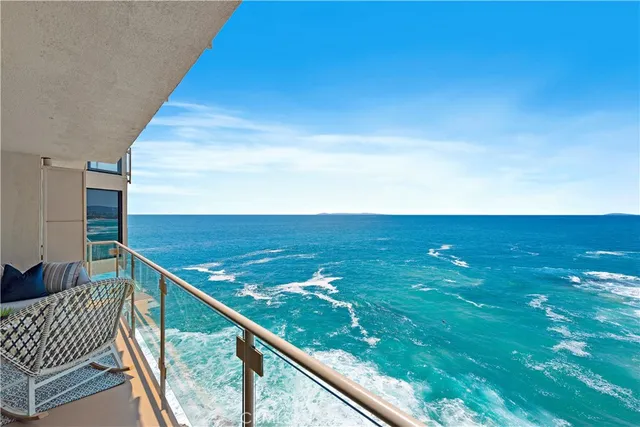 an aerial view of a house with a yard and large tree